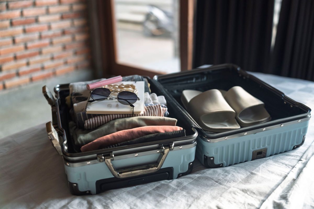 a suitcase packed with beach clothes and items